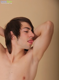 Smooth chested Jackson Banx licks his own cum